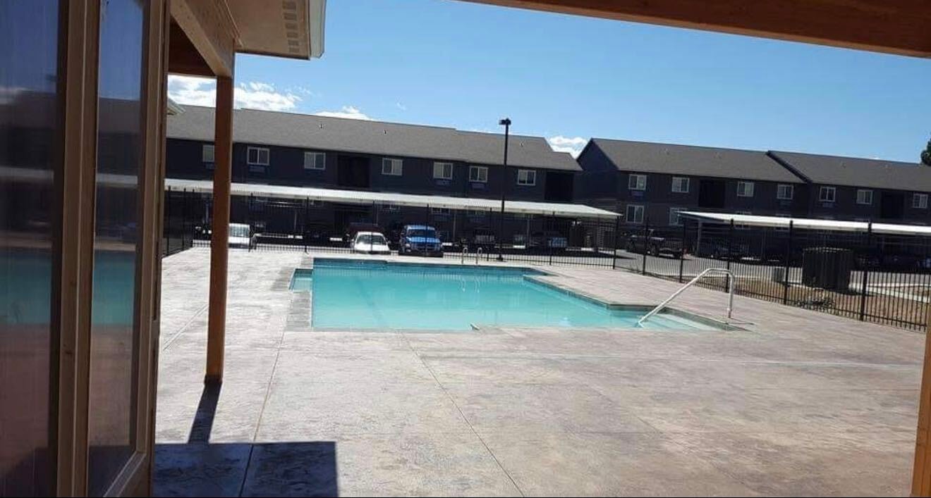 Commercial pool with stamped concrete deck and iron fencing